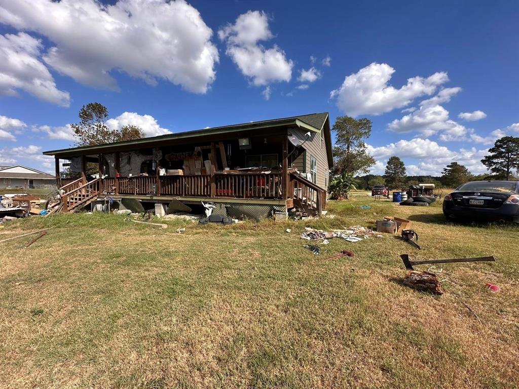 a view of a house with cars parked