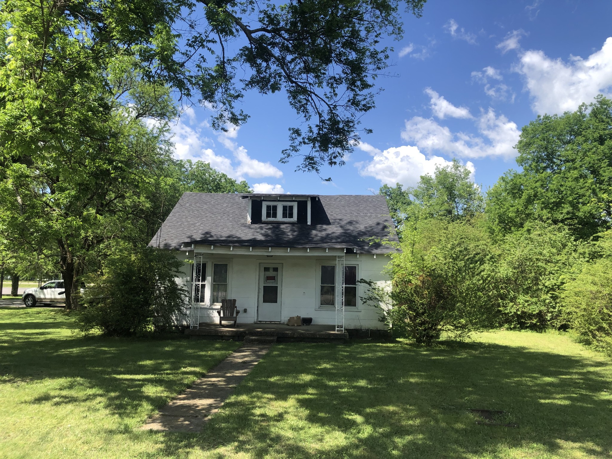 a front view of a house with a garden