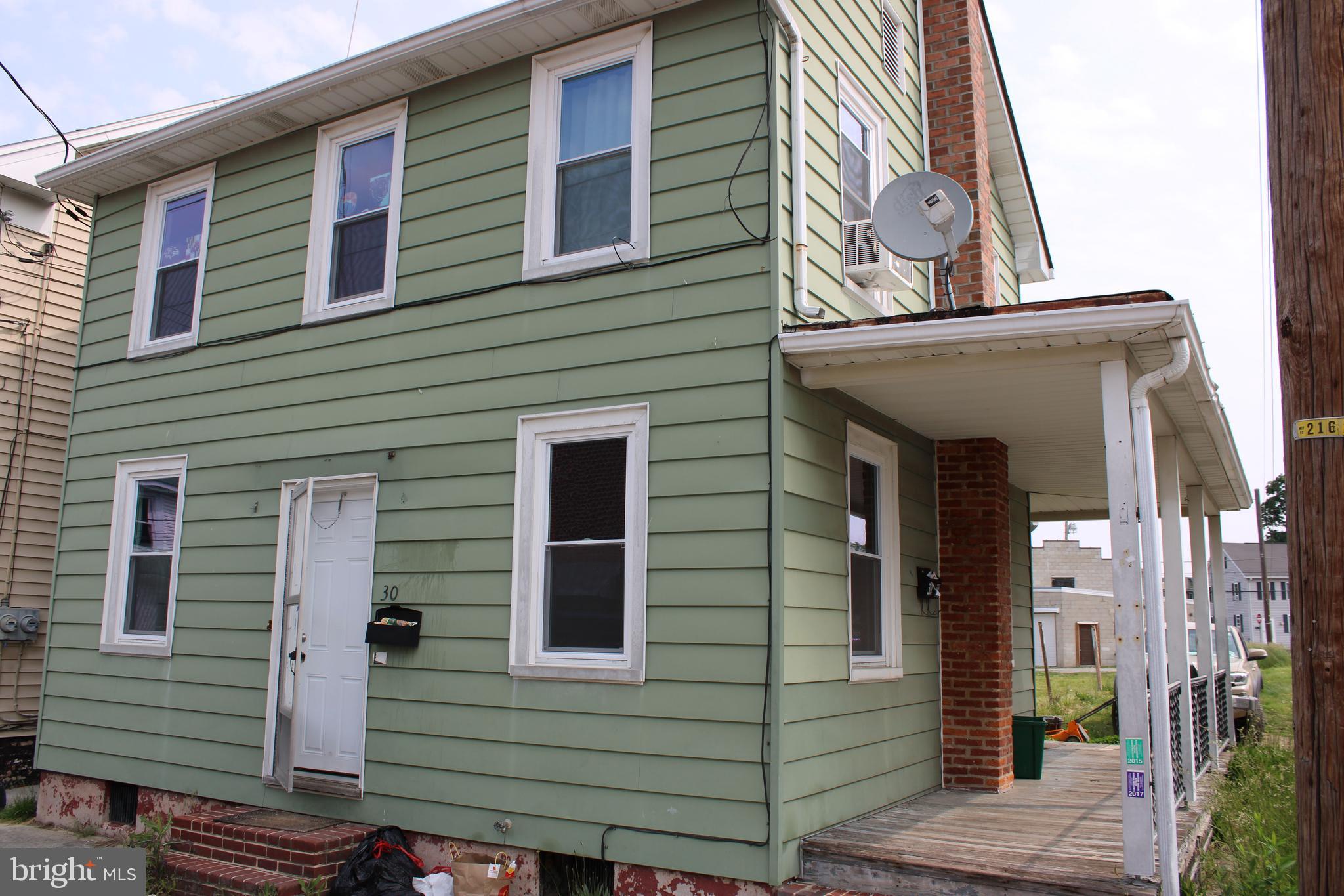 a view of a house with a window and brick walls