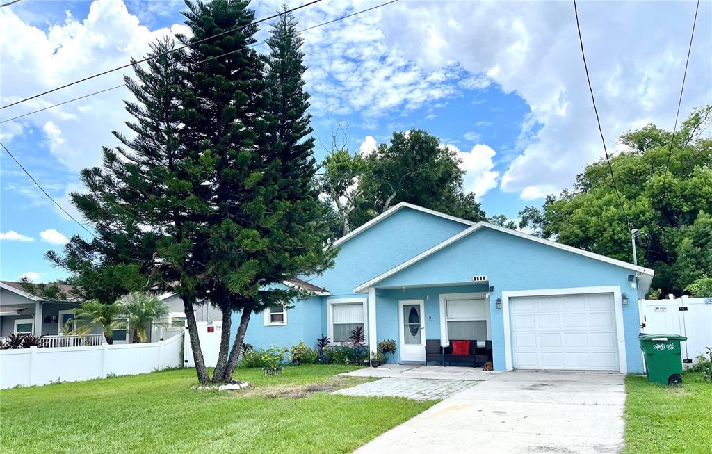 a front view of house with yard and green space