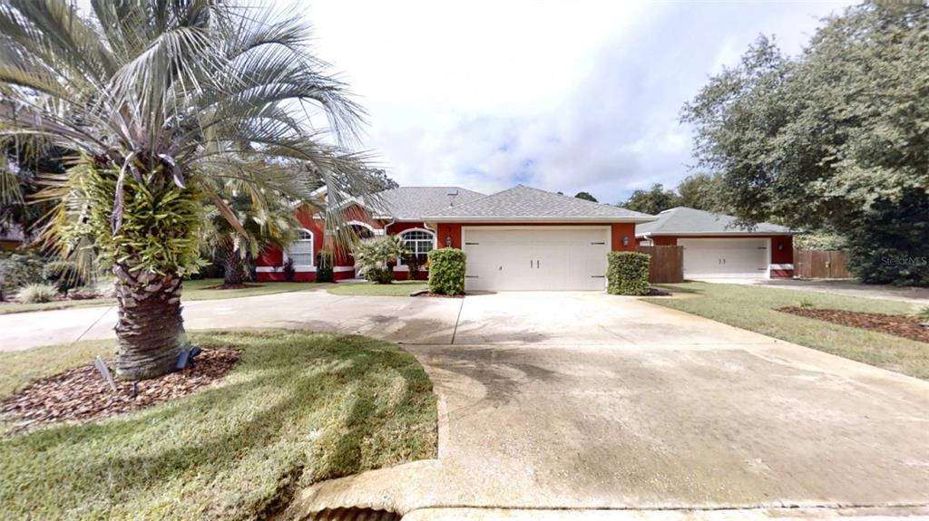 a front view of a house with a yard covered with snow