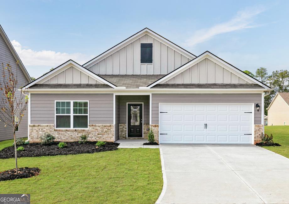 a front view of a house with a yard and garage