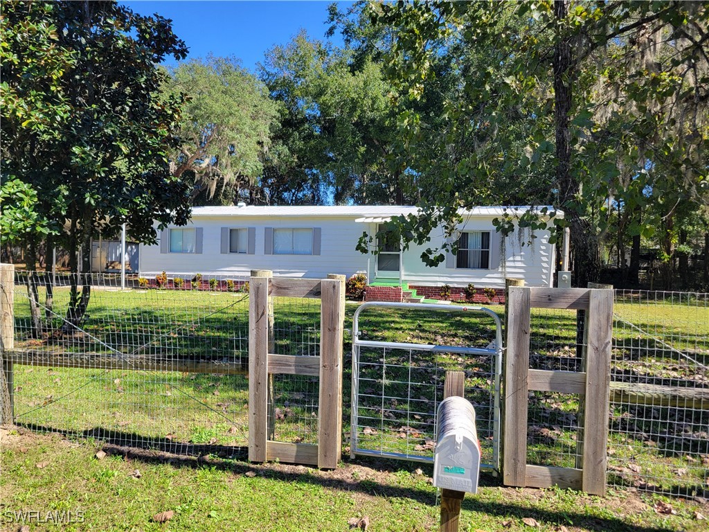 a view of a house with backyard from a patio