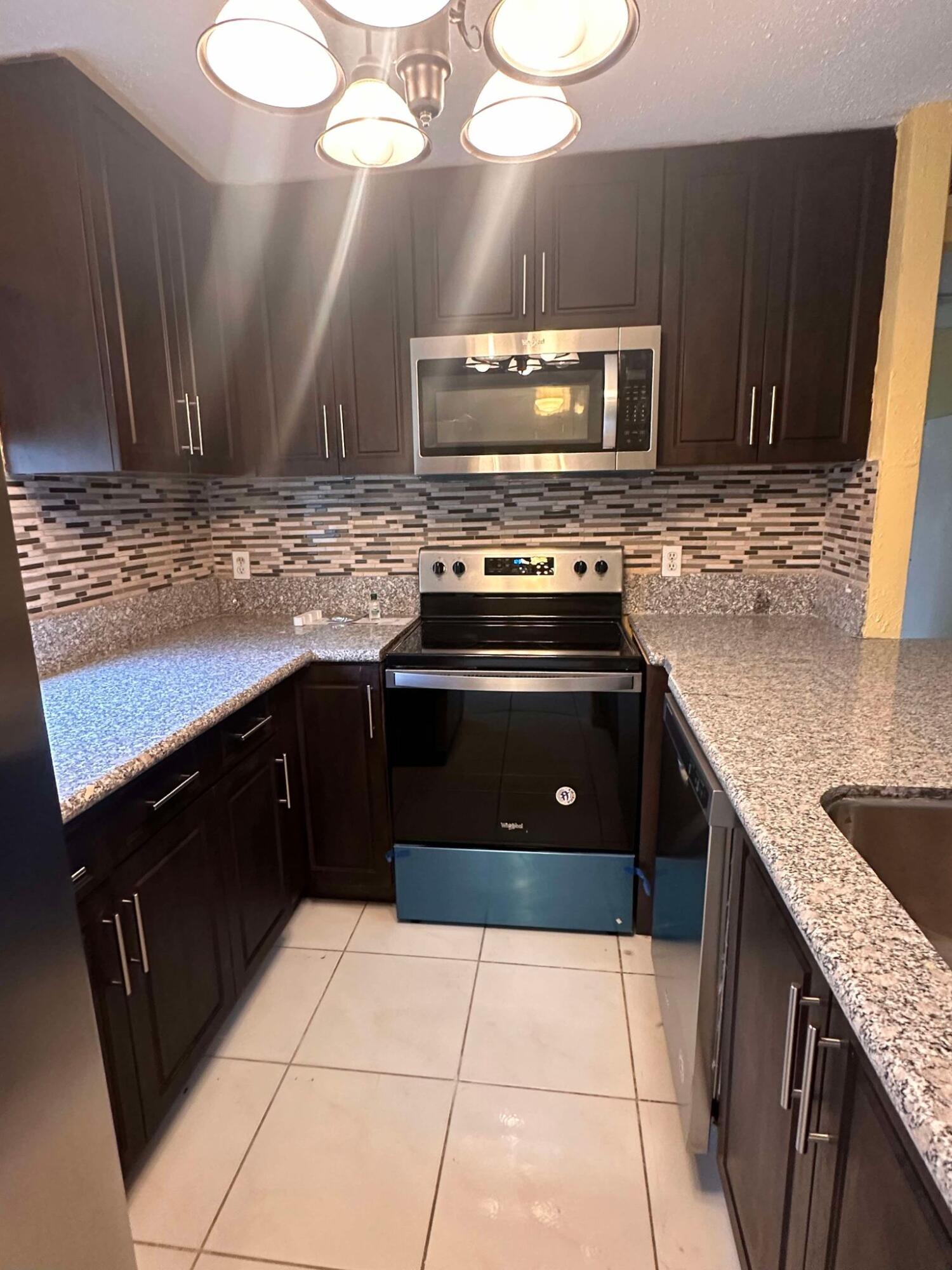 a kitchen with a stove microwave and sink