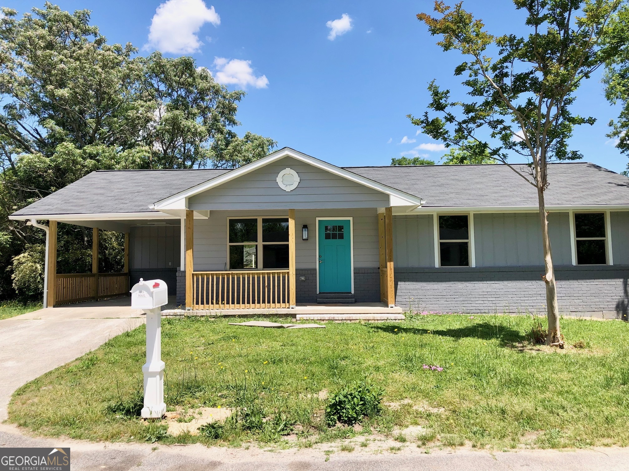 a front view of a house with a yard and porch