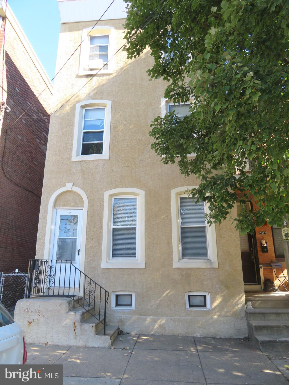 a front view of a house with outdoor seating