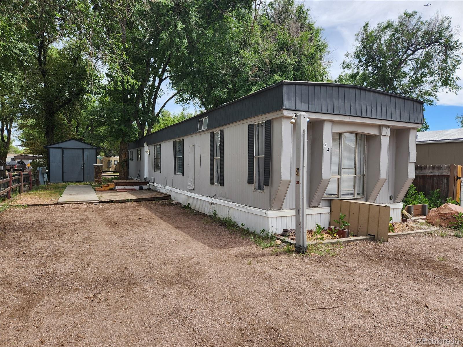 a view of a house with yard and wooden fence