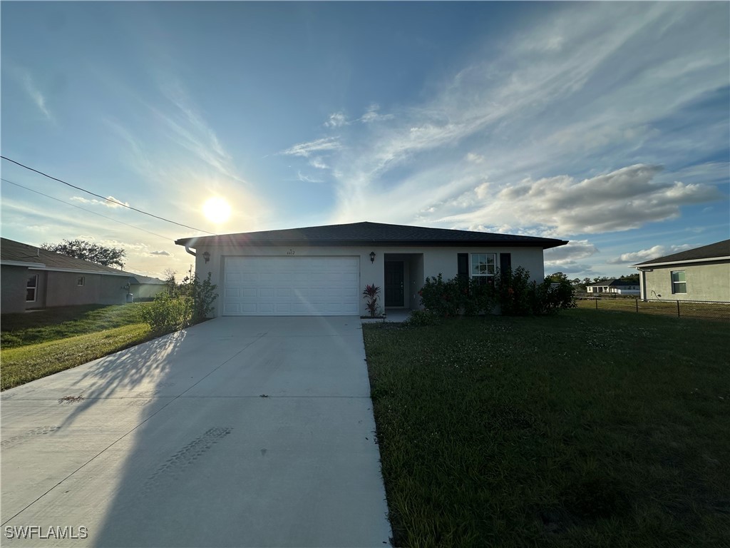 a front view of a house with a yard and garage