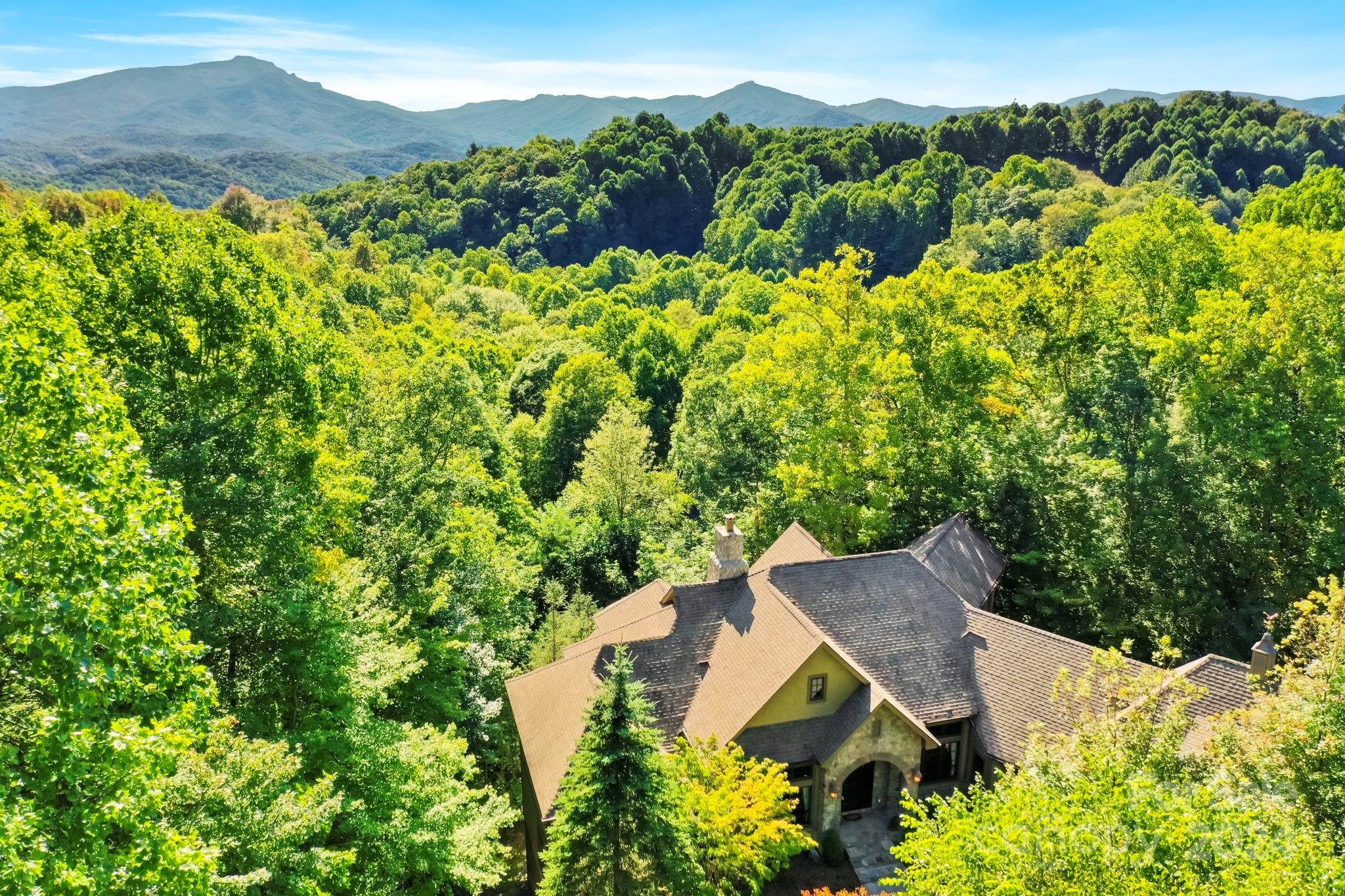 an aerial view of a house with a yard