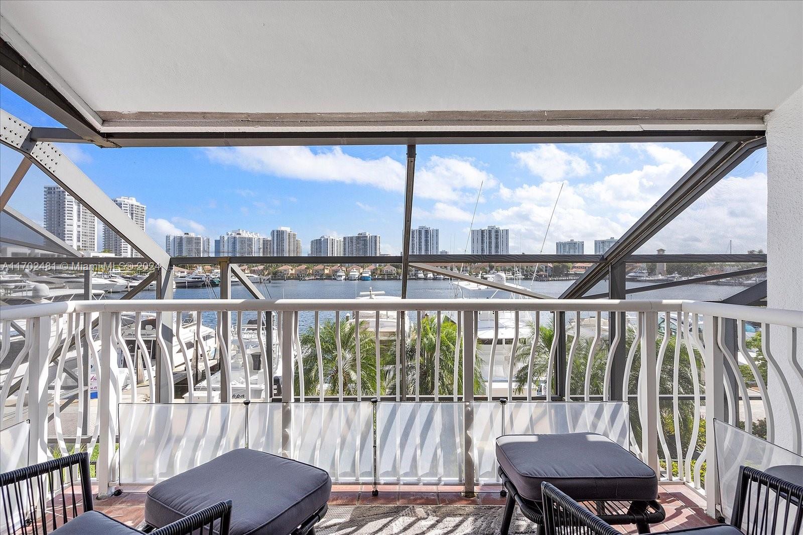 a view of a city from a balcony with furniture