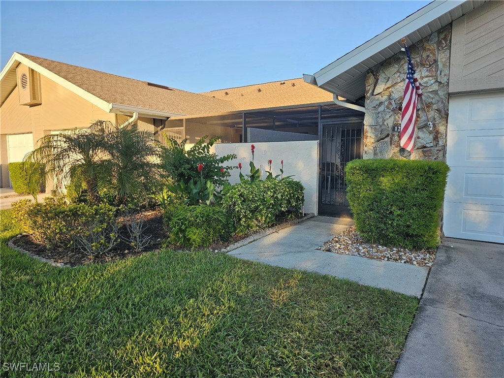 a view of a house with a small yard and plants