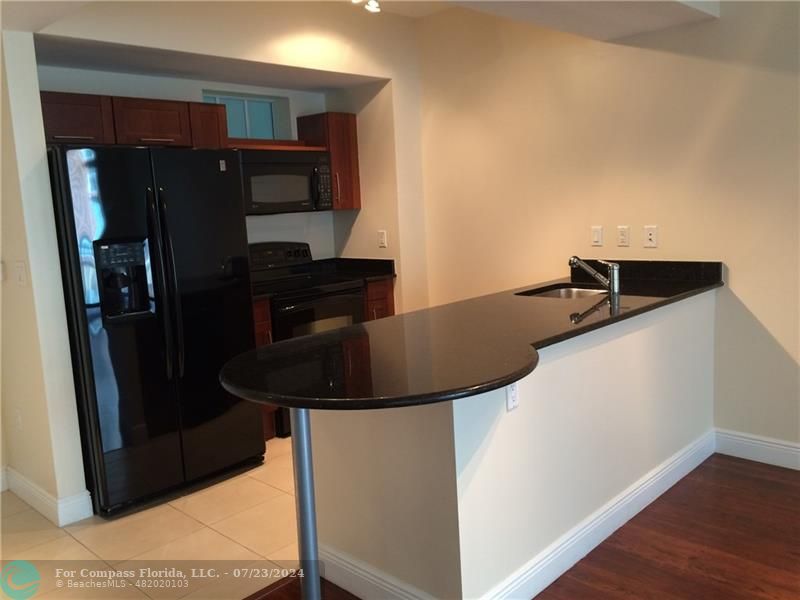 a kitchen with a refrigerator and cabinets