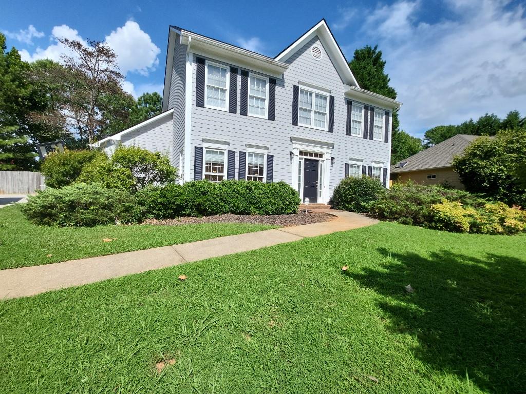 a front view of a house with a yard