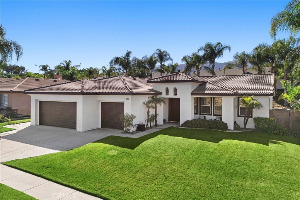 a front view of house with a garden and patio