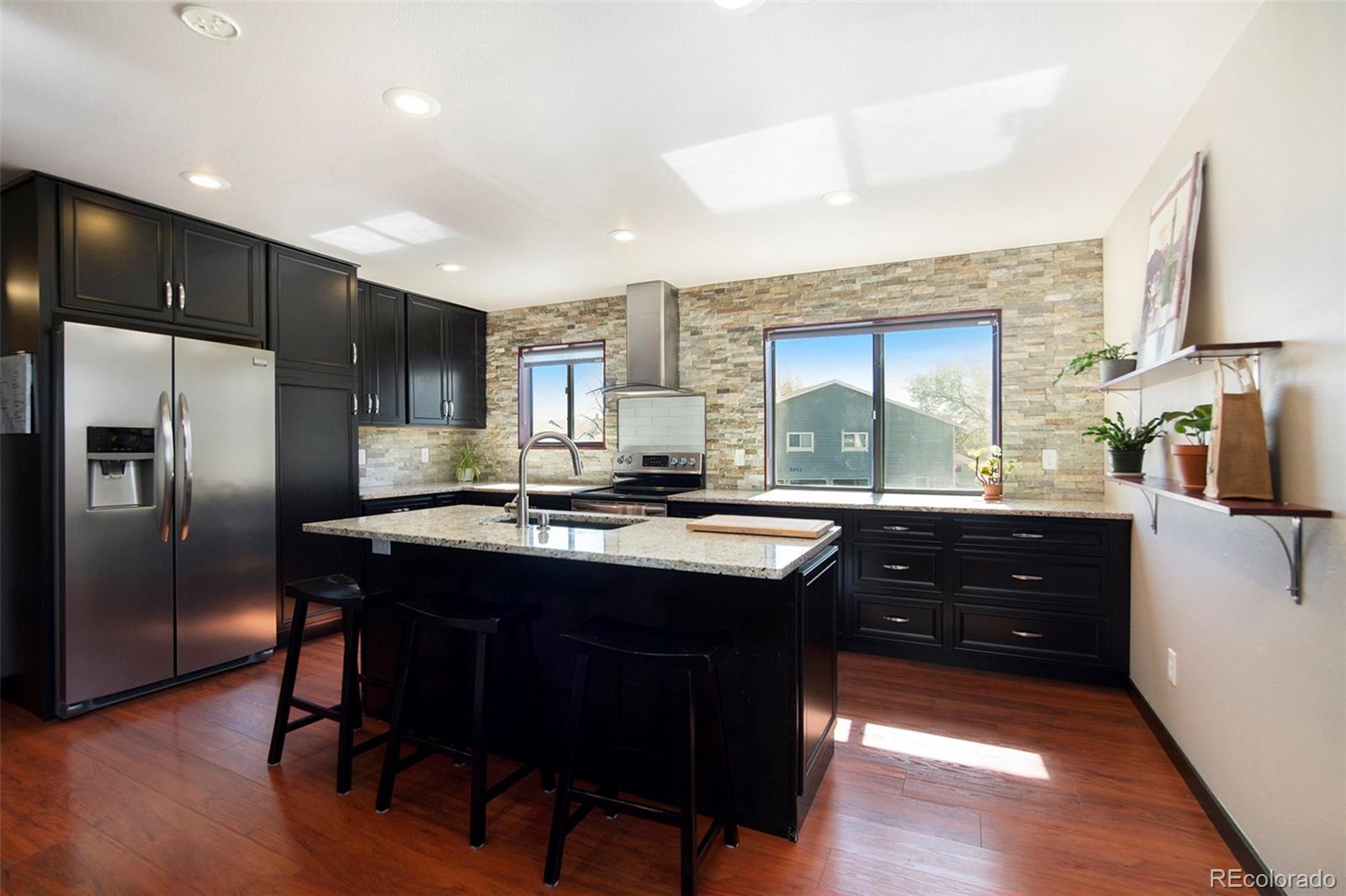 a kitchen with a sink stove and refrigerator