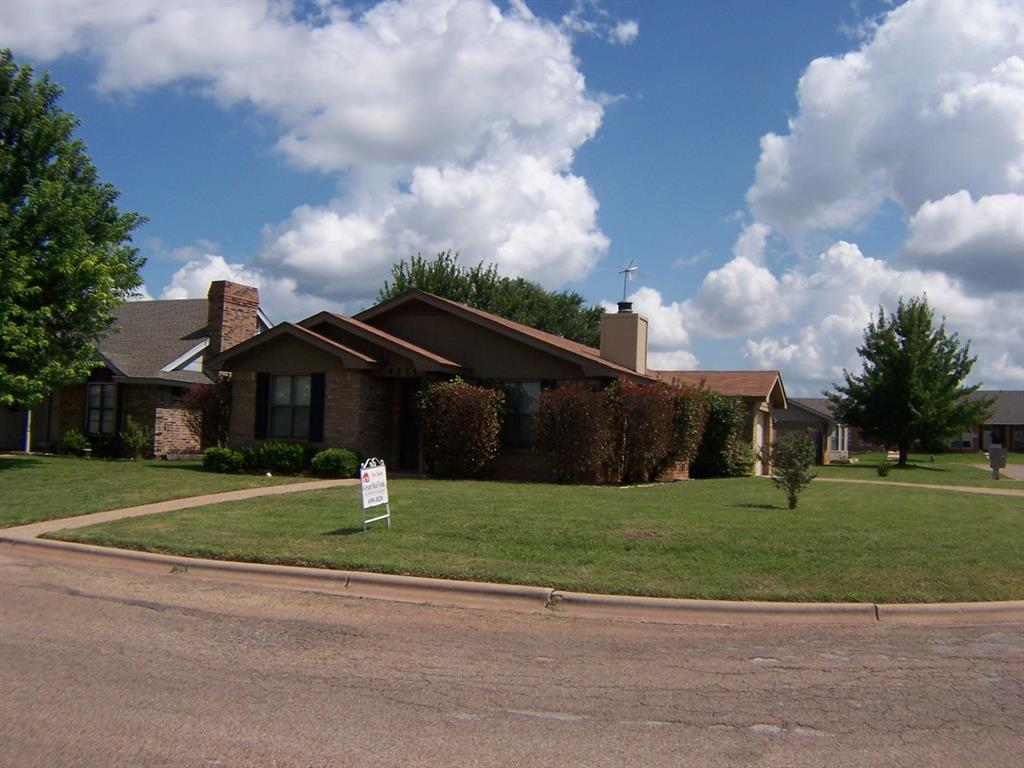 a house that has a tree in front of it