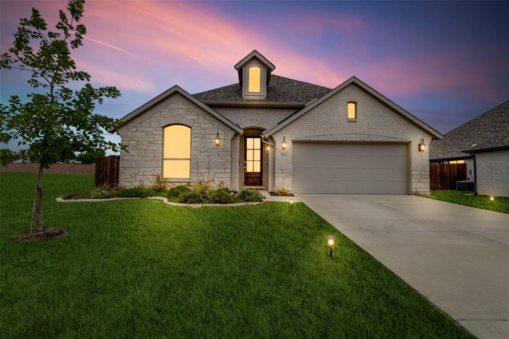 a front view of a house with a yard and garage