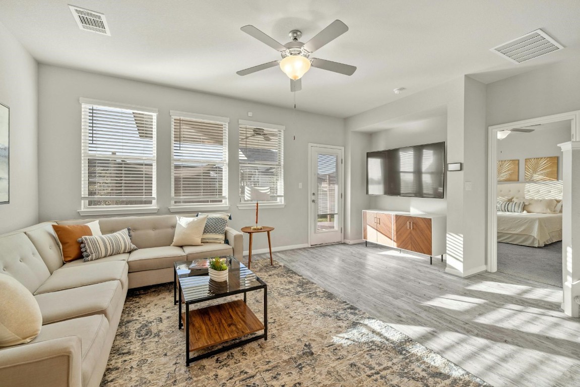 a living room with furniture and floor to ceiling windows