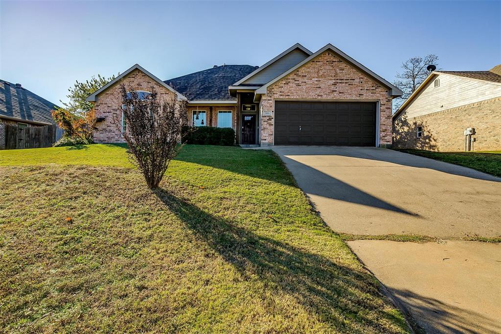 a view of a house with a yard and garage