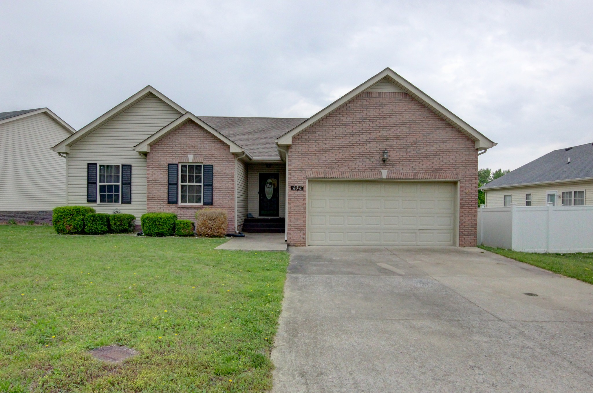 a view of a house with a yard and garage