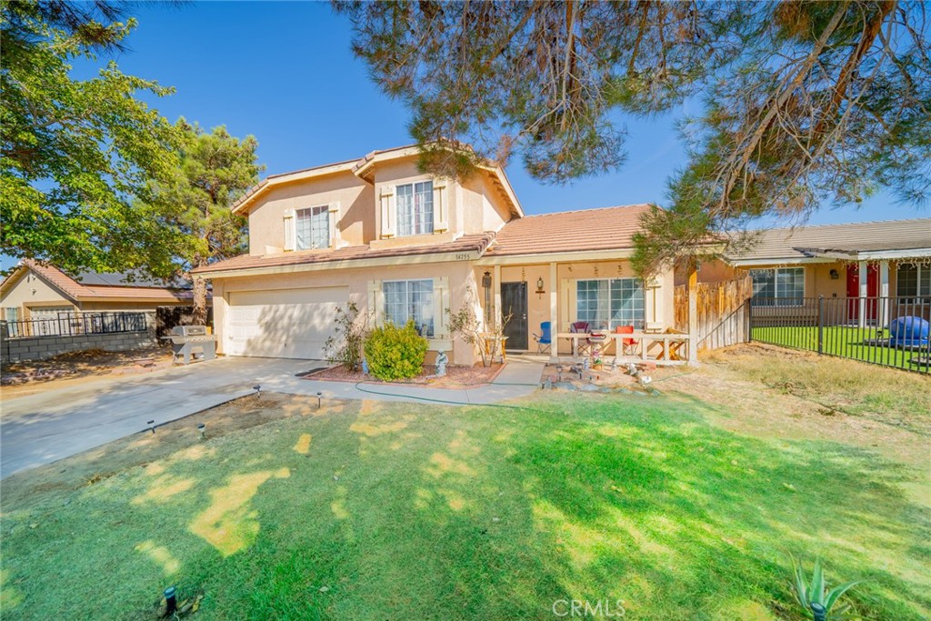 a front view of a house with yard patio and swimming pool