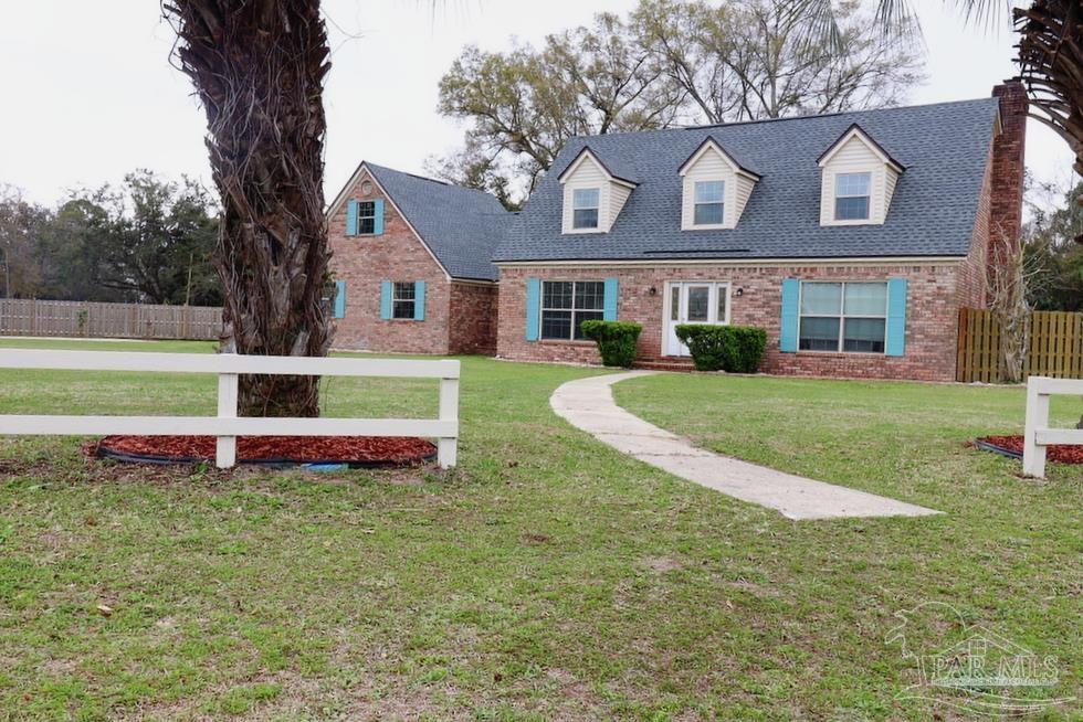 a front view of house with yard and garage