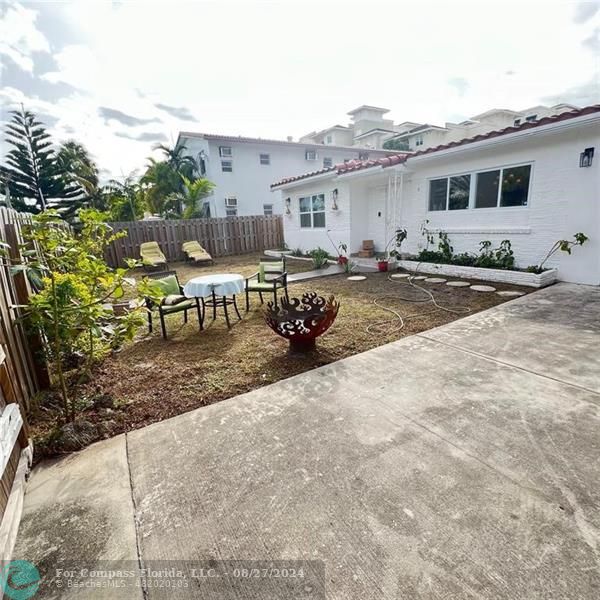 a view of a house with backyard porch and sitting area