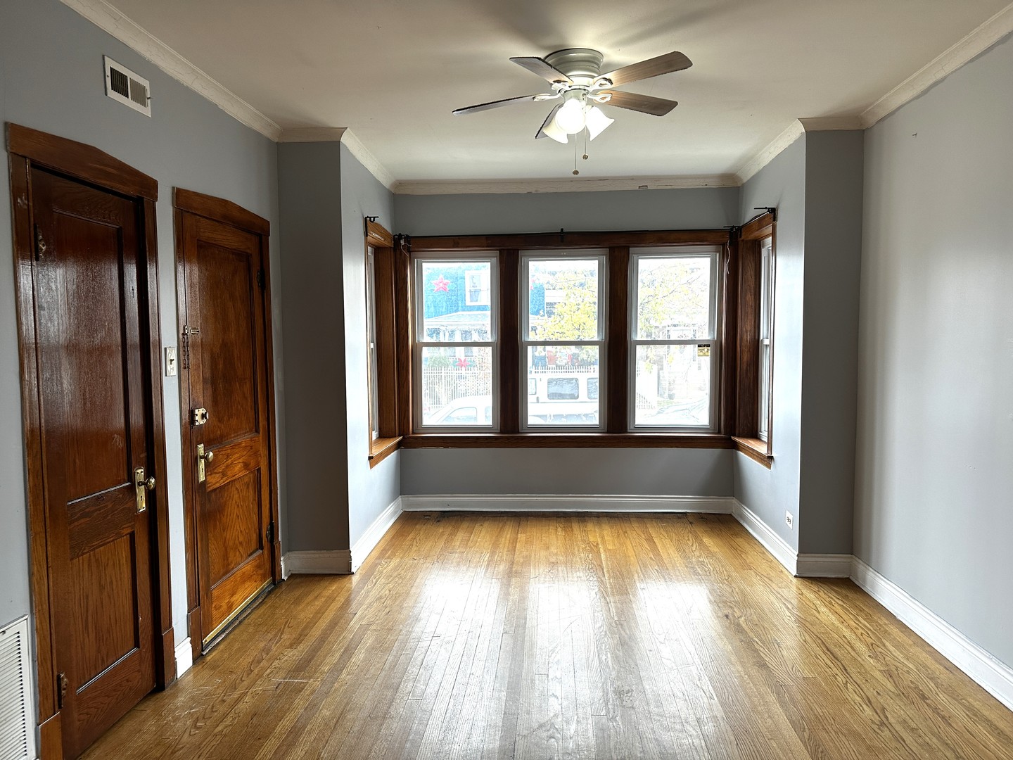 wooden floor in an empty room with a window