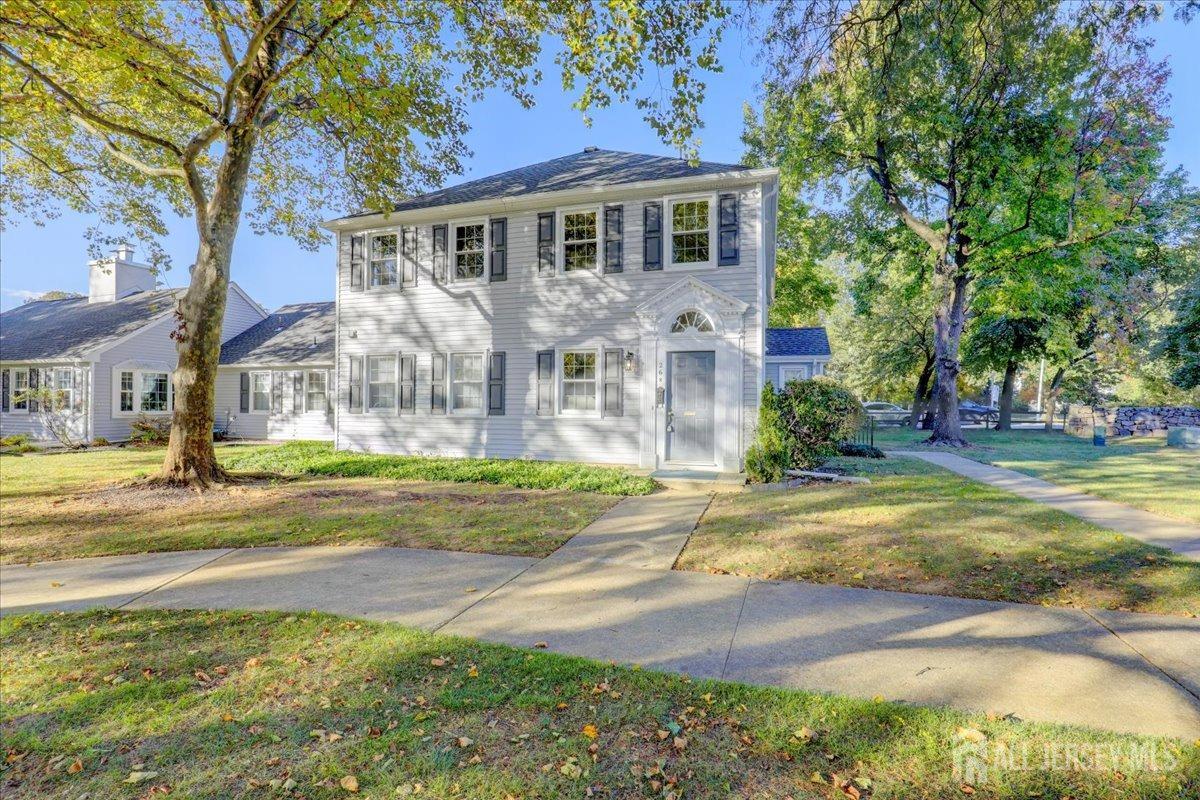 a front view of a house with yard and green space