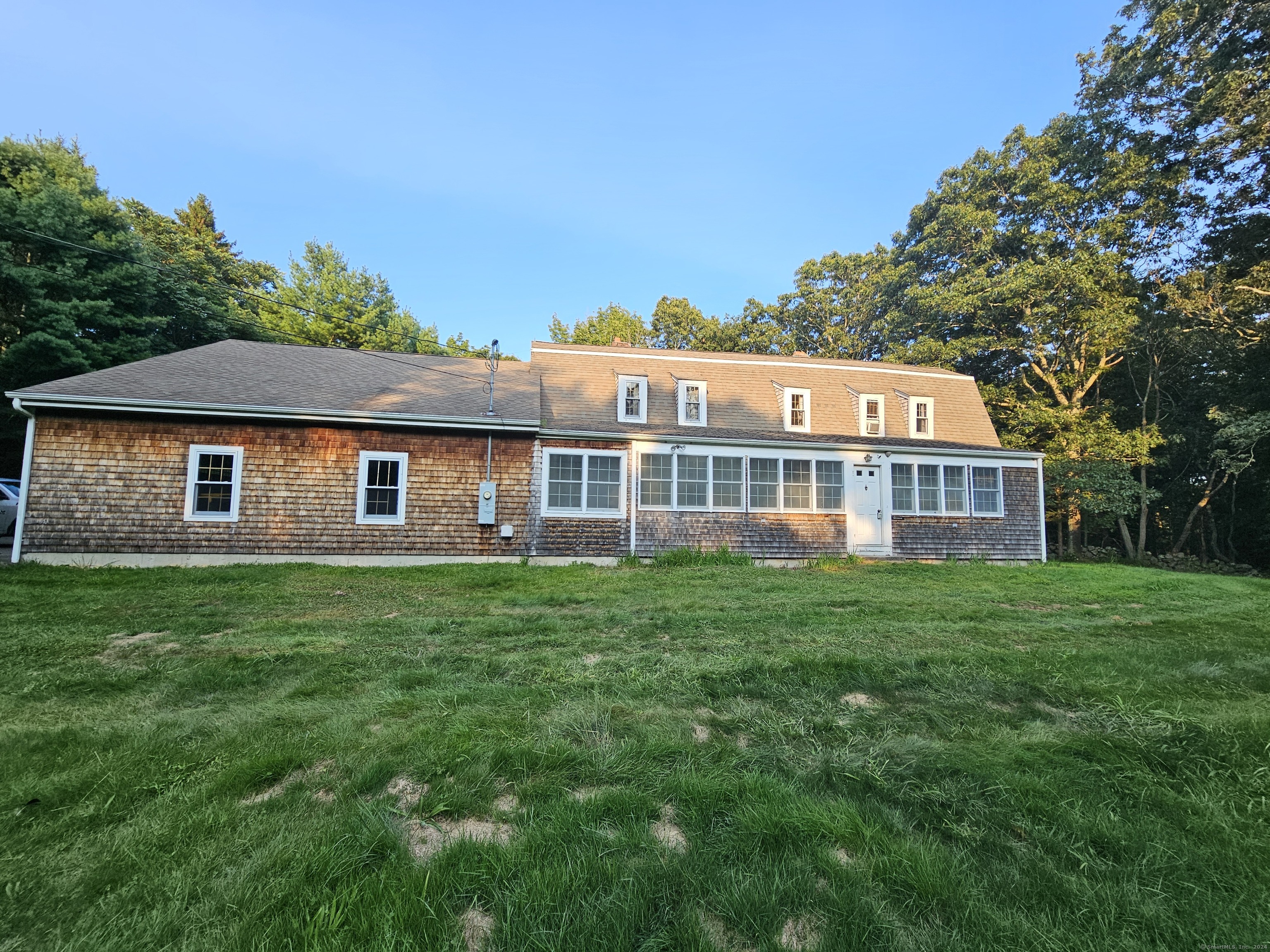 a front view of a house with a garden