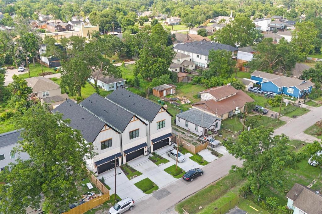 an aerial view of multiple houses with yard