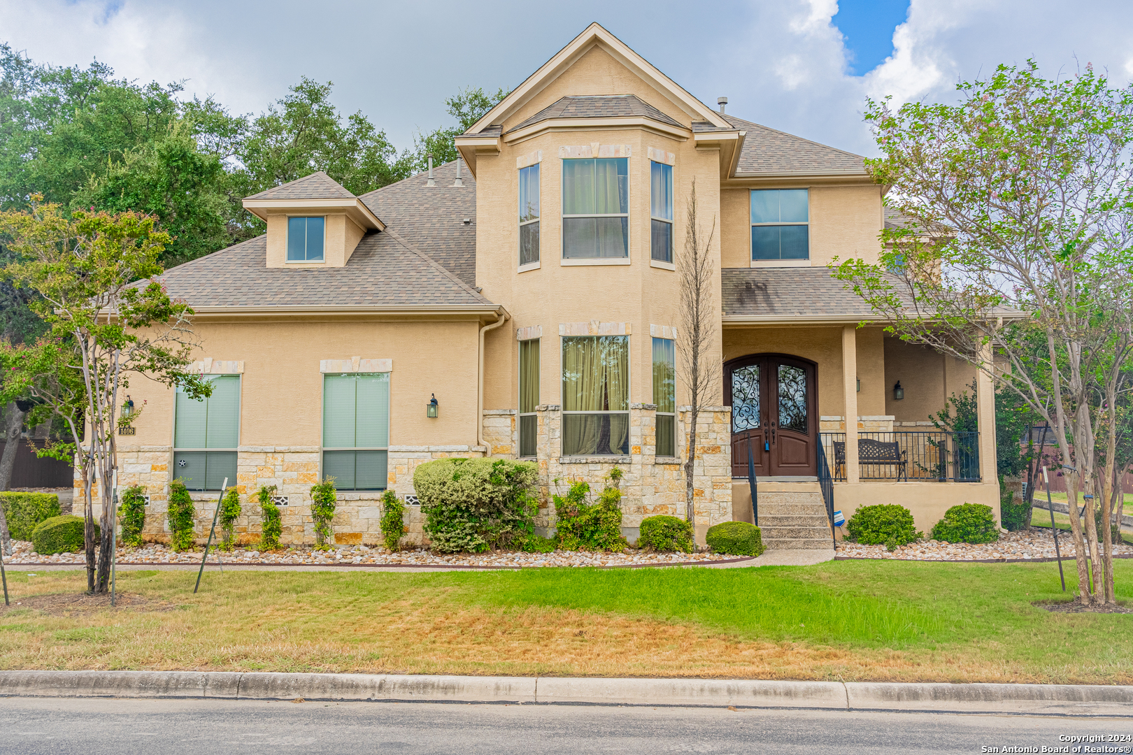 a front view of a house with a yard