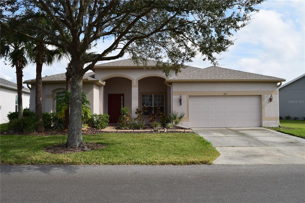 a front view of a house with a yard and garage