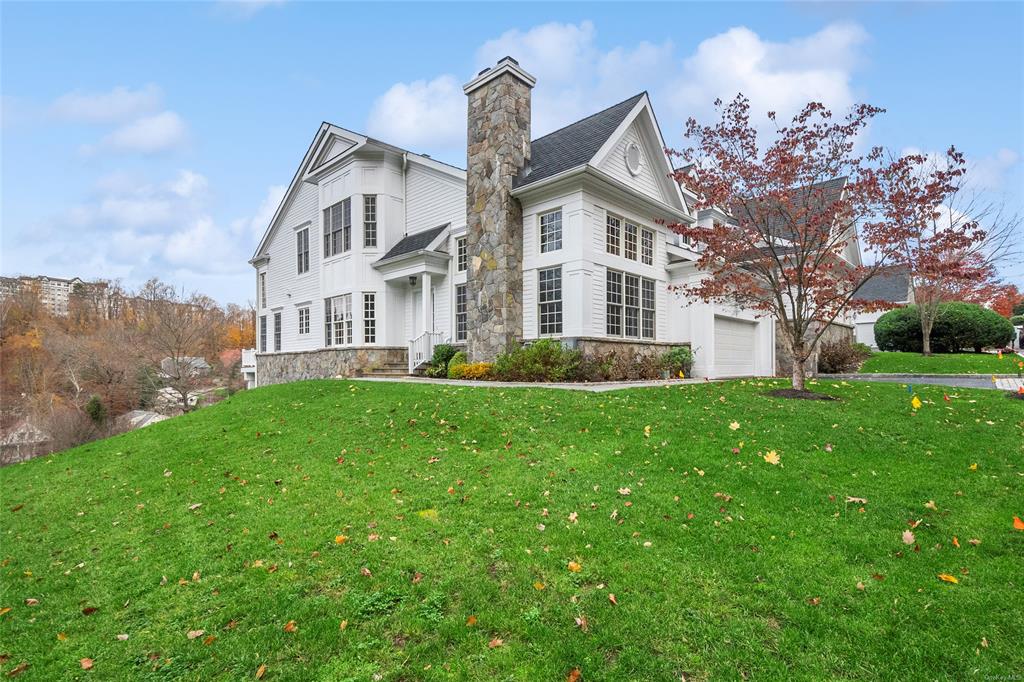 View of front facade with a front lawn and a garage