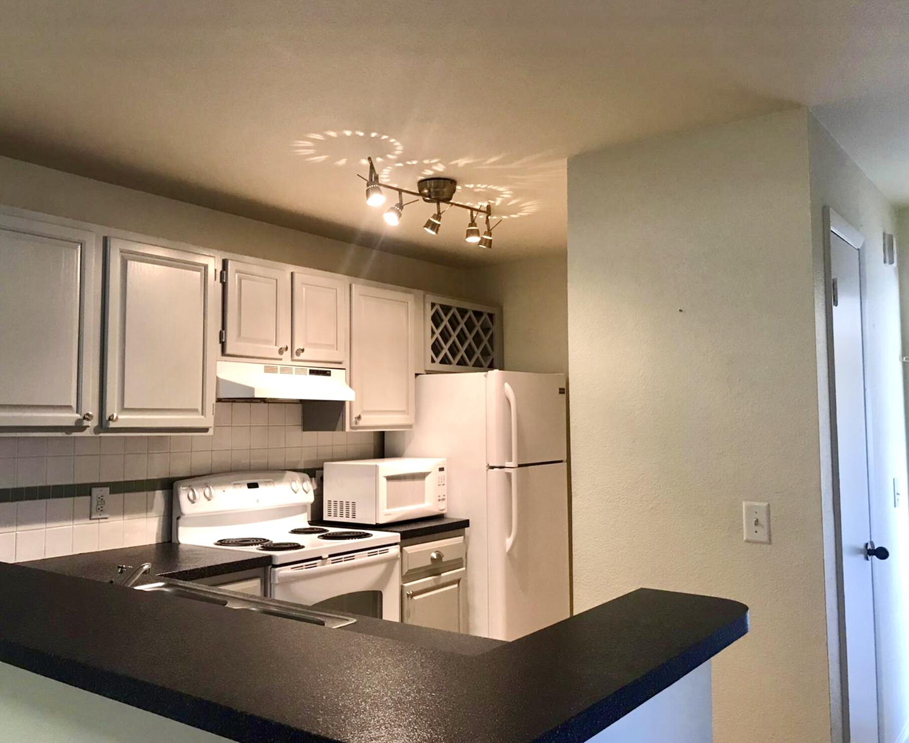 a kitchen with a refrigerator a stove a sink and a cabinets