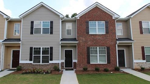 a front view of a house with a yard