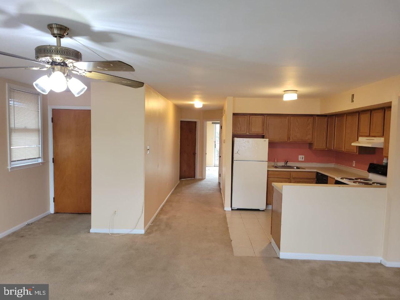 a view of a kitchen with a refrigerator a ceiling fan a kitchen a refrigerator a sink and a refrigerator