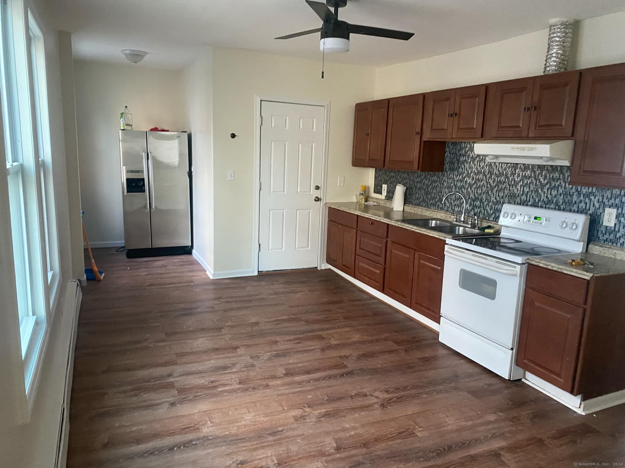 a kitchen with stainless steel appliances granite countertop a stove a sink and a refrigerator