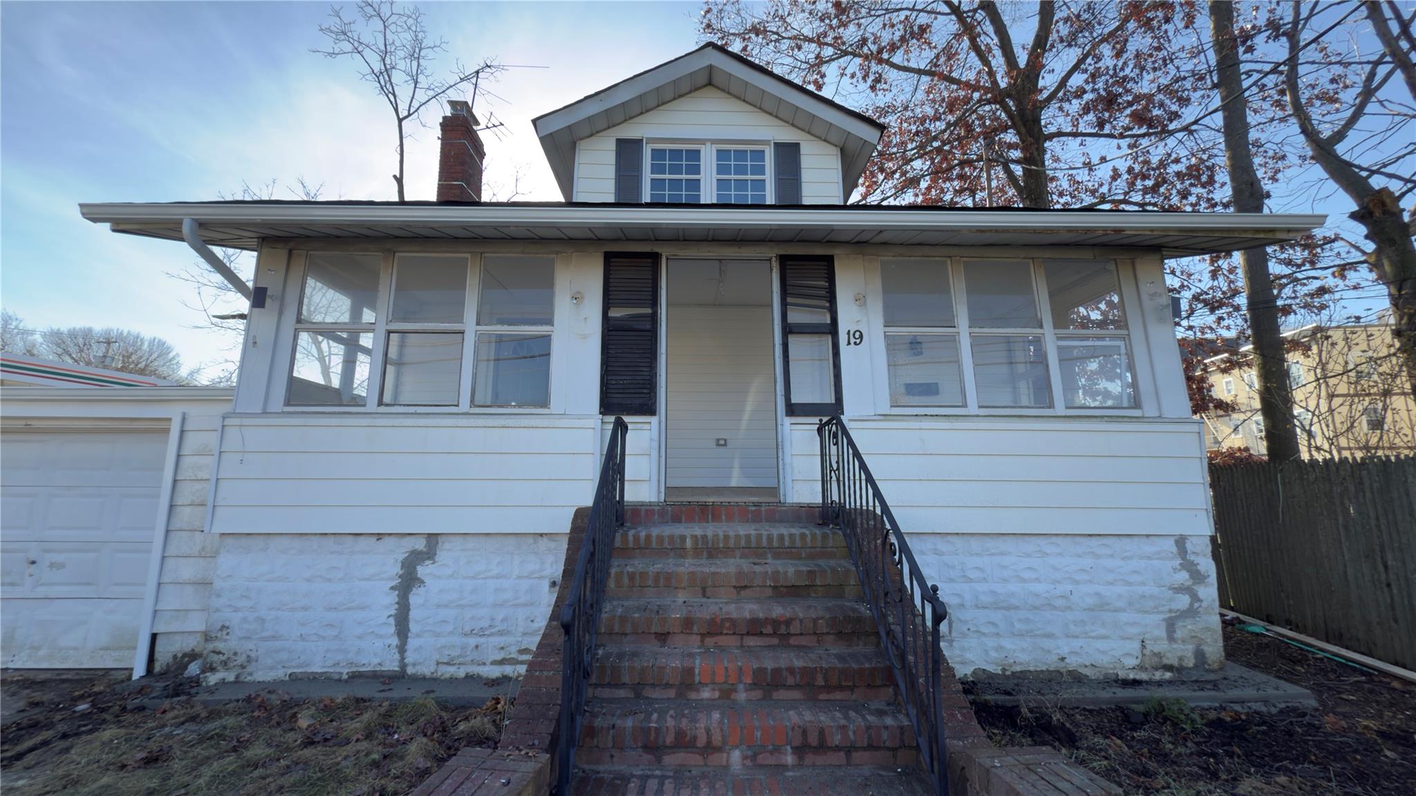 View of front of house featuring a garage and an outdoor structure