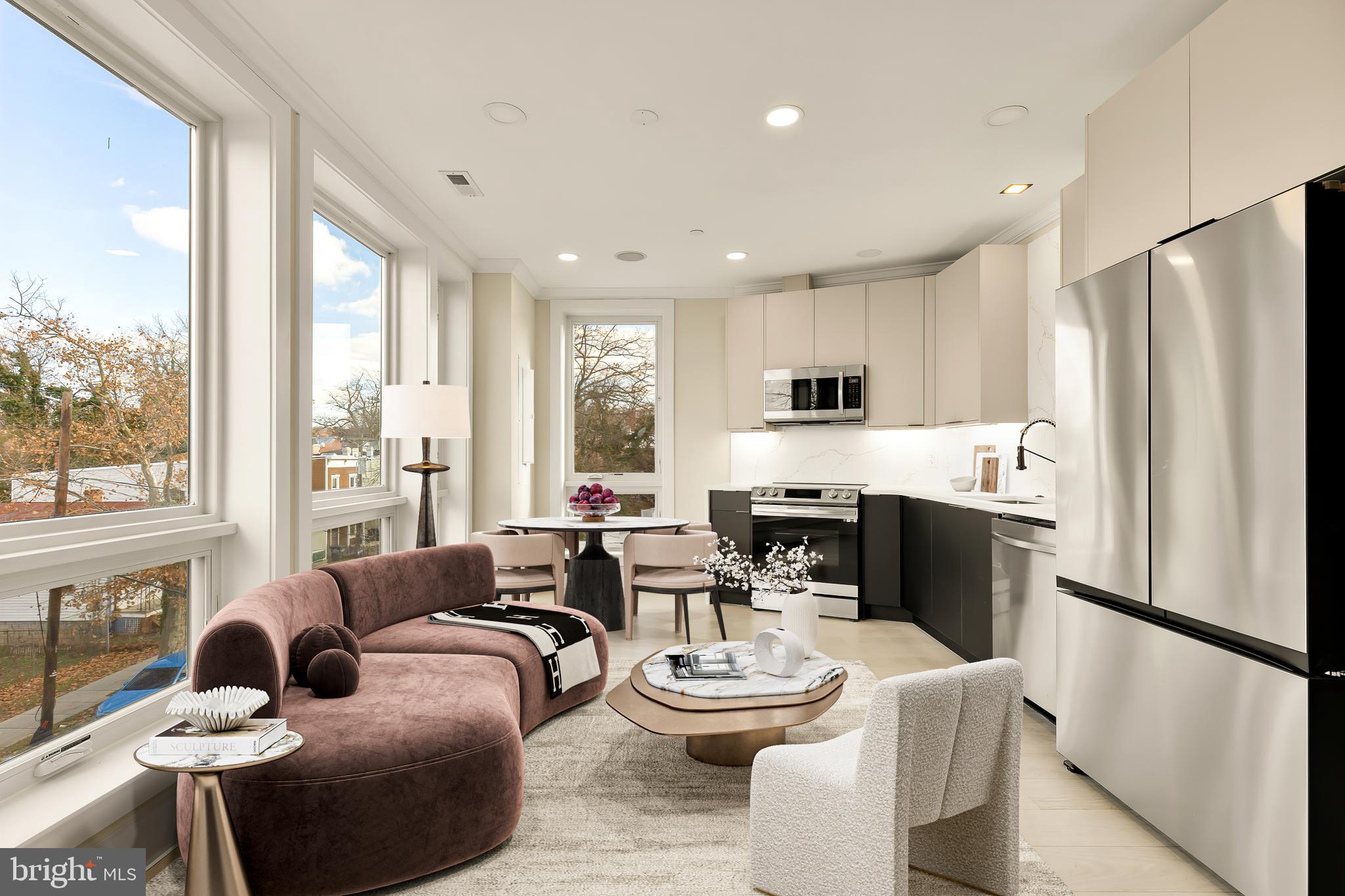 a living room with fireplace furniture and a large window