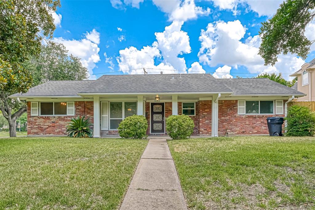 a front view of a house with a yard and porch