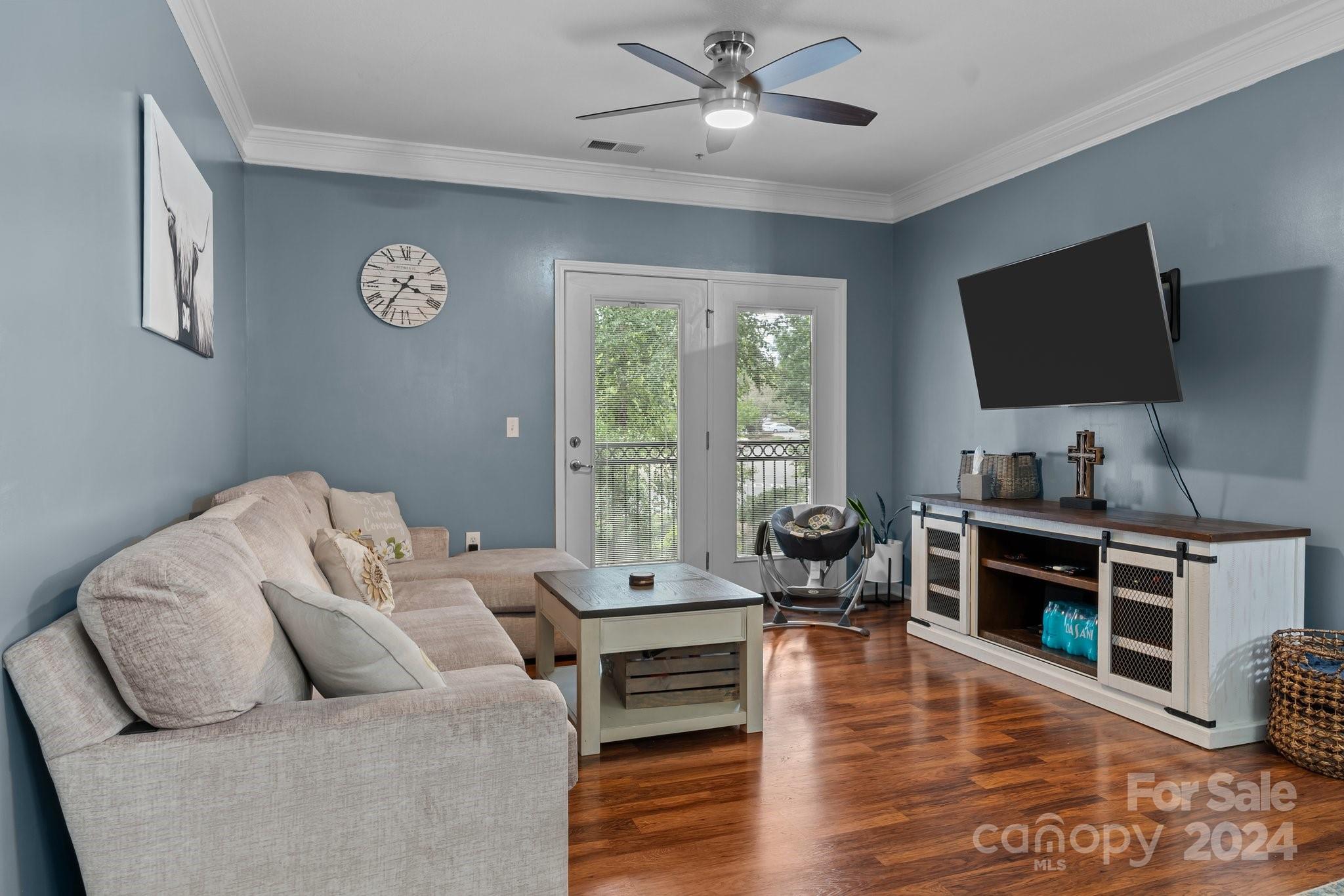 a living room with furniture and a flat screen tv