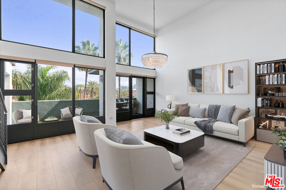 a living room with furniture and large window