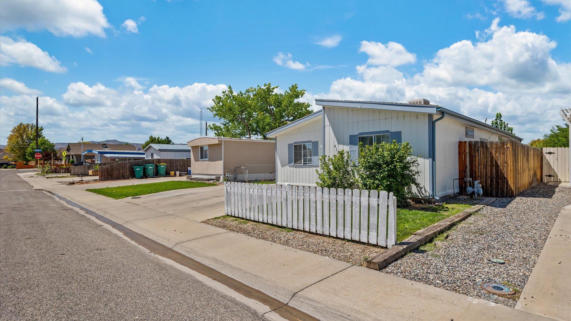 a view of a house with wooden fence