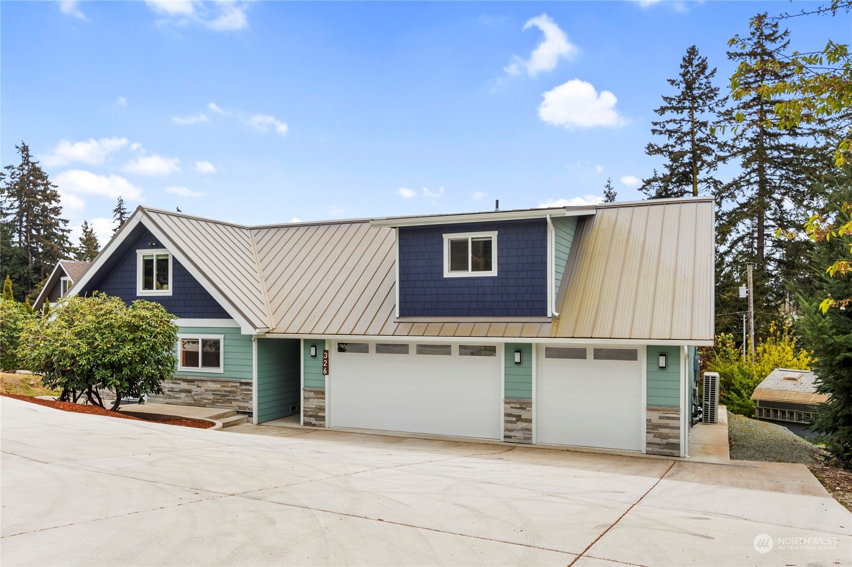 a view of a house with a patio and a yard