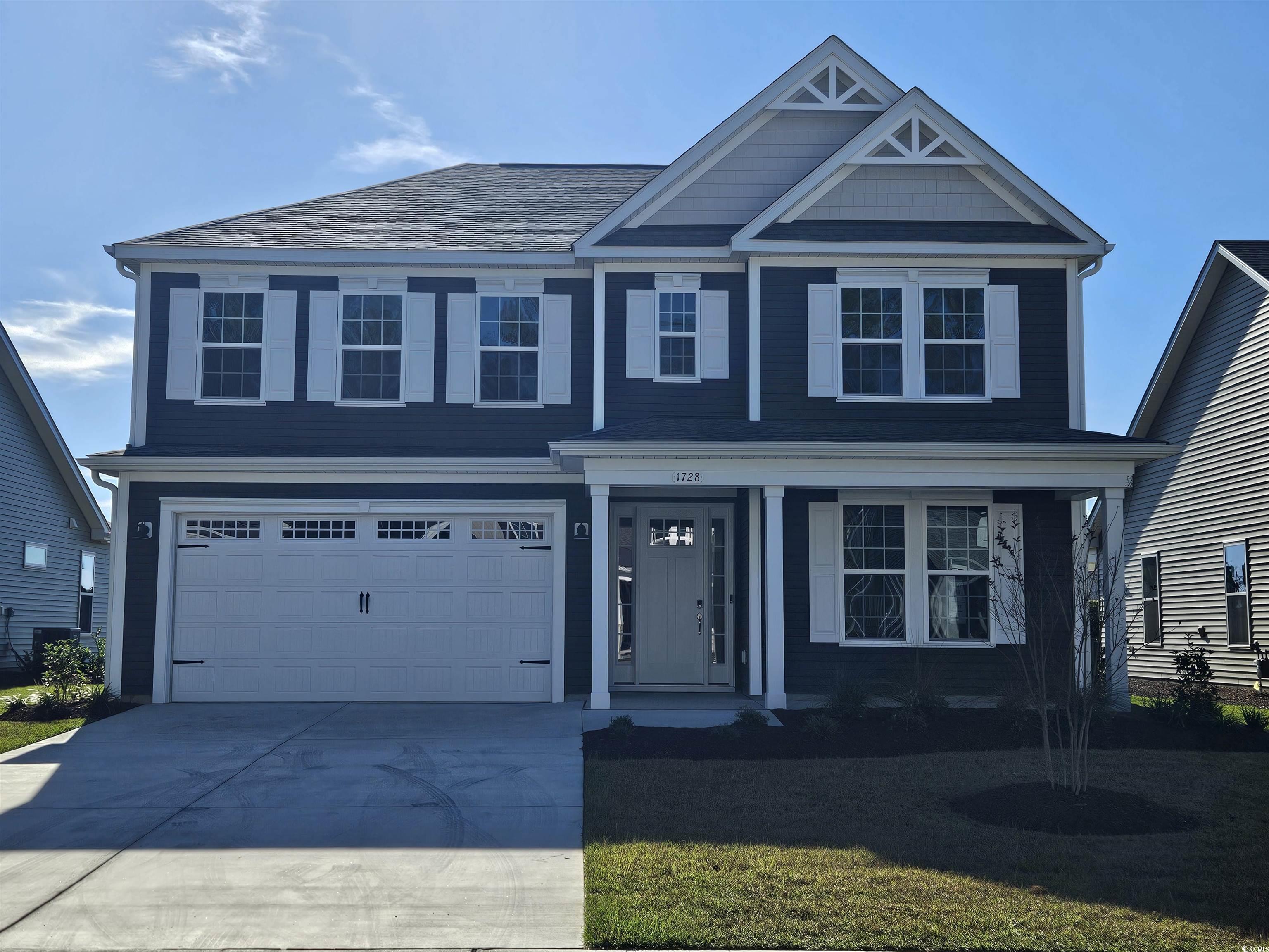 View of front facade featuring a garage