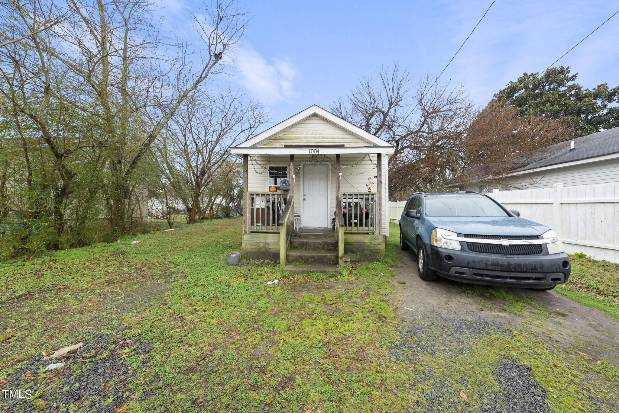 a view of a yard with a house and a large tree