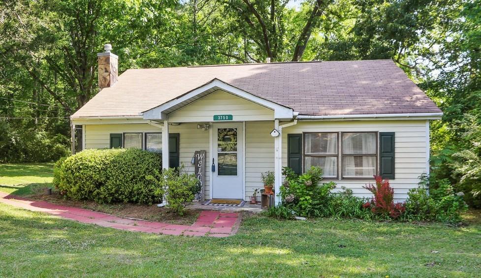 a view of a house with a yard and plants