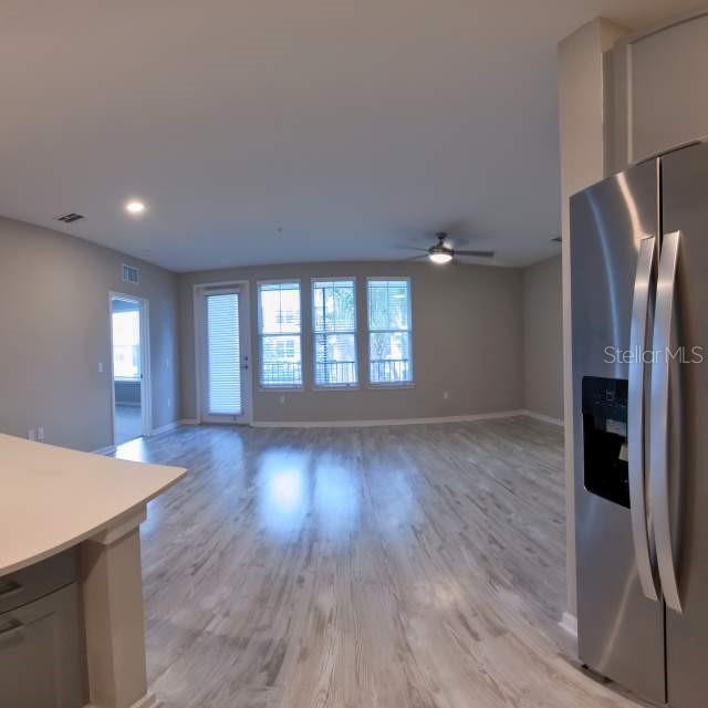 a view of livingroom with hardwood flooring and hallway