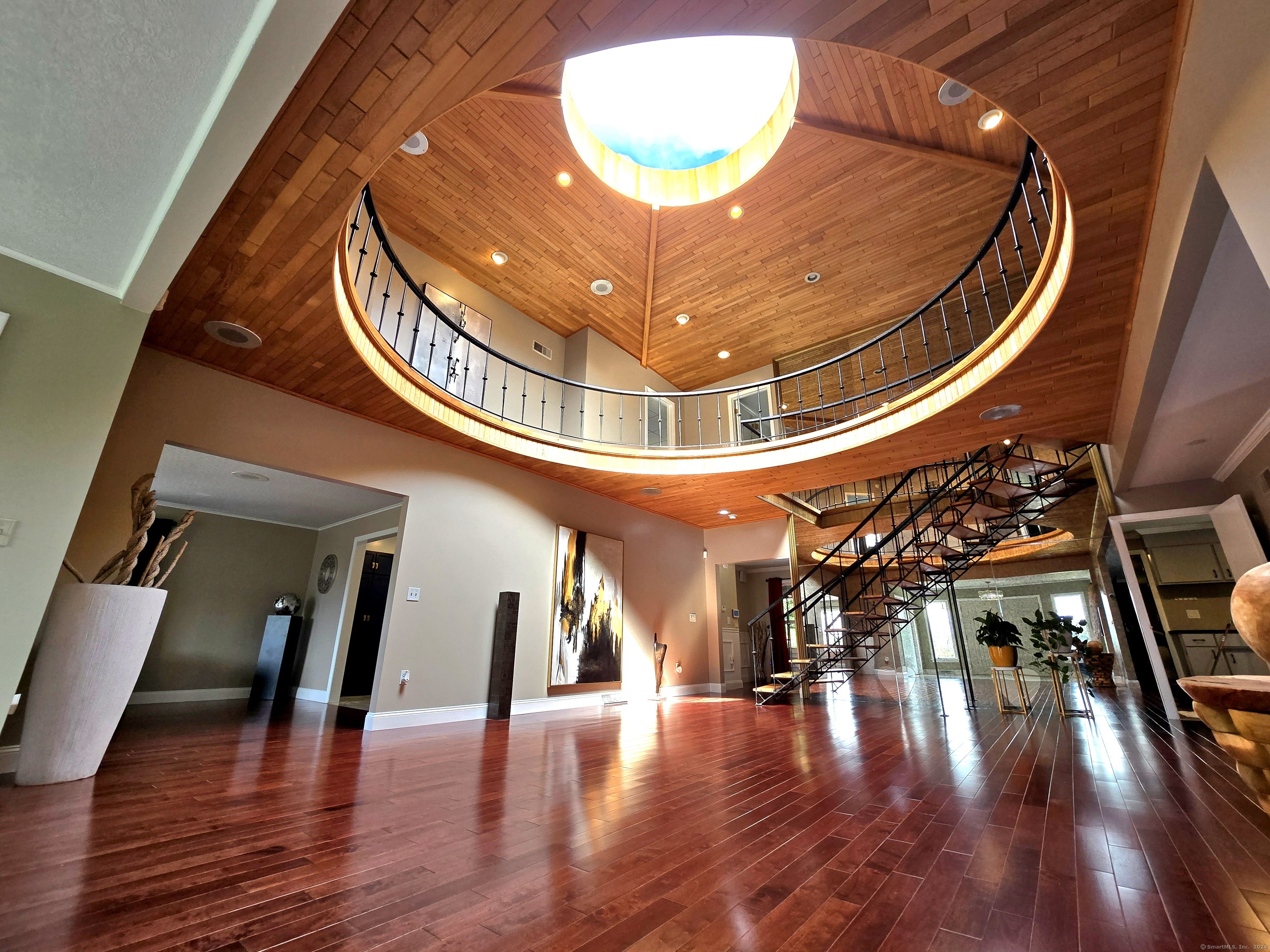 a view of entryway and hall with wooden floor